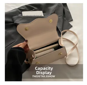 Detail view of the beige crossbody bag showing interior capacity for phone and wallet