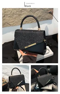 Detail of black faux leather shoulder bag with sequined flap and gold hardware