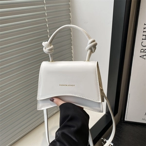 Minimalist white leather crossbody square bag with knot handle and gold fashion lettering