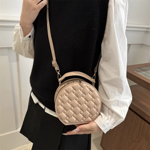 Quilted round crossbody bag in beige PU leather with top handle and chain strap