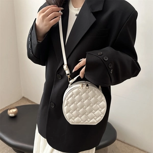 Chic white round quilted crossbody bag with gold chain and woven leather texture