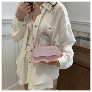Detail of pink glitter flap and wave edge design on a stylish crossbody square bag