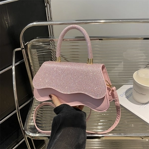 Pink rhinestone embellished handbag with wave edges and elegant silver strap