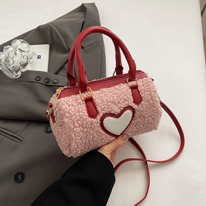 Pink plush cylindrical boston bag with red heart patch and detachable crossbody strap