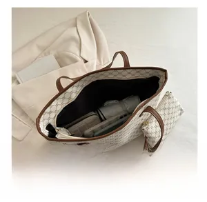 Close-up of a large vintage monogram tote bag interior showing spacious capacity with pouch