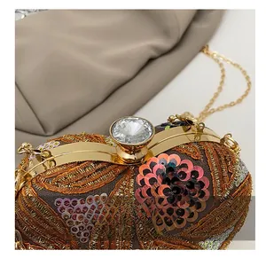 Macro view of luxurious sequin embroidery and large diamond clasp on the fashion clutch