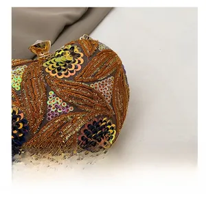 Close-up of golden sequins and floral embroidery detail on a luxury evening clutch