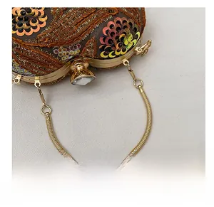 Detailed macro view of vintage sequin clutch with golden handle and crystal clasp lock
