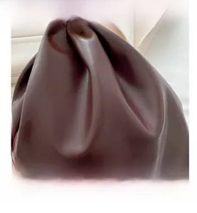 Detailed view of the dark brown pleated cloud bag with soft faux leather texture