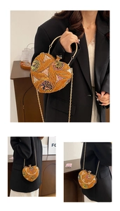 Detail of floral sequin heart evening bag with gold ring handle and detachable chain