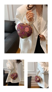 Detail view of heart-shaped evening bag with purple sequins and beaded floral patterns