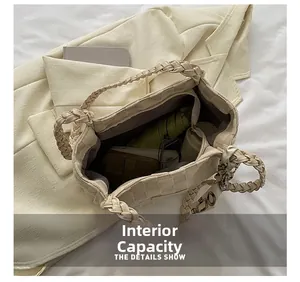 Spacious interior of beige woven tote bag showing daily essentials and zip pocket