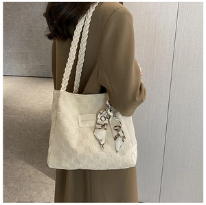 Detailed texture of off-white woven tote bag with vintage silk scarf and fashion patch