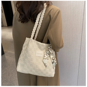 Detail of cream canvas tote bag with woven braid straps and vintage scarf decoration