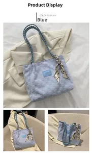 Detail of blue tote bag with checkerboard texture and elegant silk scarf handle