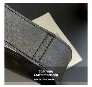 Detail of high-quality stitching craftsmanship on black pebble leather handbag strap