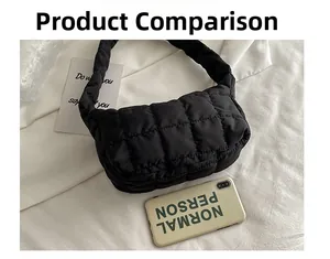 Close-up of black quilted puffer shoulder bag with size comparison to a phone case