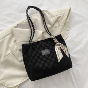 Large black woven tote bag with handle scarf and fashion tag on white fabric