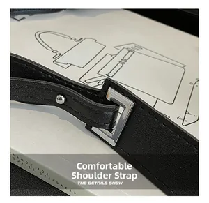Detail of adjustable black leather strap with silver buckle and refined stitching
