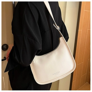 Fashionable white leather underarm bag with New York print worn by a model in black