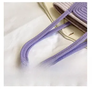 Detail of woven cotton rope shoulder strap in purple and beige on a stylish tote bag
