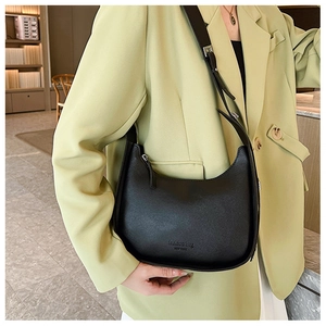 Detail of black crescent shoulder bag with New York print and silver buckle strap