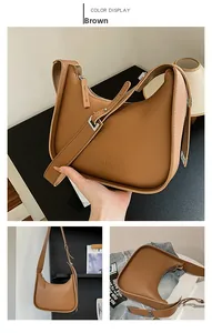Detail of brown hobo bag showing zipper closure, logo text and adjustable strap