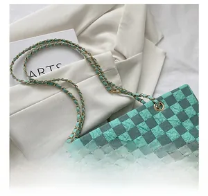 Detail of green checkerboard tote with gold chain strap and crinkled bubble texture