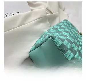 Detailed view of mint green quilted checkerboard tote bag with precise stitching