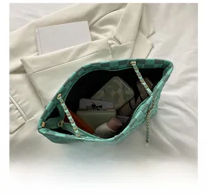 Detailed internal view of checkered tote bag showing large storage capacity and items