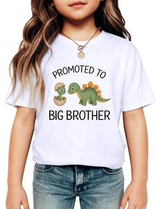 Close-up of cute dinosaur graphic with Promoted to Big Brother text on white T-shirt