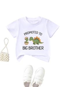 Detail view of cotton t-shirt with Promoted to Big Brother dinosaur print and sneakers