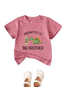 Detail view of pink T-shirt with dinosaur print and Promoted to Big Brother slogan