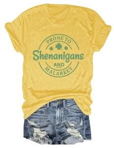 Flat lay of yellow cotton t-shirt with shenanigans print and ripped denim shorts
