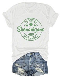 Flat lay of white t-shirt with Saint Patrick's Day graphic and distressed denim shorts