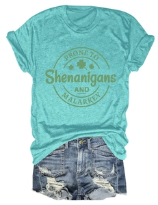 Close-up of teal St. Patrick's Day t-shirt text detail with distressed denim shorts