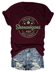 Detail of burgundy crew neck tee with festive slogan and distressed denim shorts
