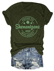 Flat lay of olive green cotton t-shirt with Shenanigans print and ripped denim shorts