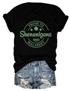Flat lay of black Saint Patrick's Day t-shirt paired with distressed denim shorts