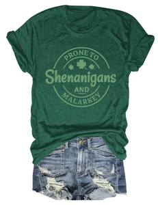 Close-up of green cotton t-shirt with Shenanigans slogan print and distressed denim shorts
