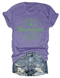 Flat lay of purple cotton blend tee with graphic print and distressed denim shorts