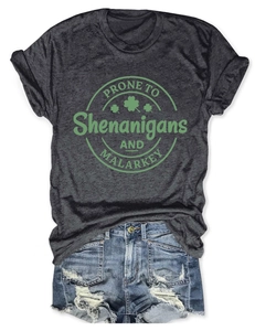 Flat lay of a grey short-sleeve T-shirt with green logo and distressed denim shorts