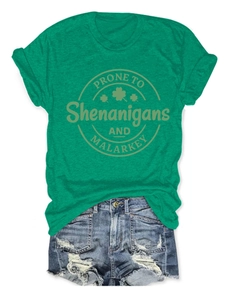 Flat lay of green shamrock t-shirt and distressed denim shorts for St. Patrick's Day