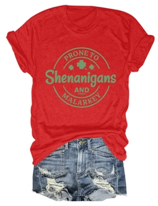 Flat lay detail of red St. Patrick's Day t-shirt with slogan and distressed denim shorts