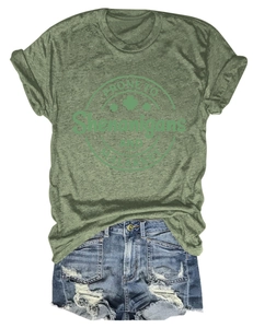 Detail of green T-shirt with Shenanigans text and distressed denim shorts set