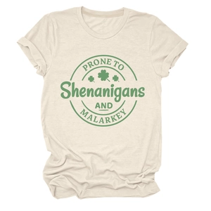Detail of shamrock graphic and lettering on a beige crew neck short sleeve cotton T-shirt