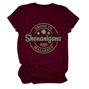 Flat lay of burgundy short sleeve T-shirt with green clover art and slogan