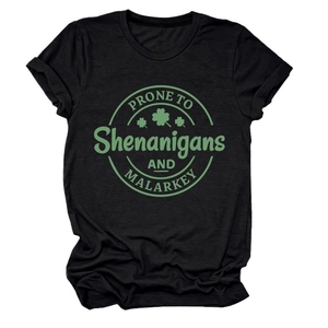 Detail of St. Patrick's Day cotton T-shirt with green clover print on black fabric