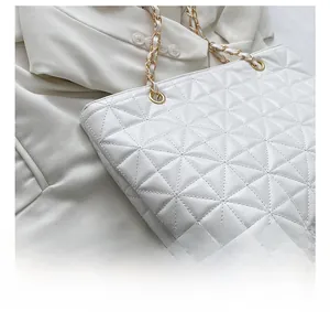 Detailed macro view of white quilted faux leather texture with precise geometric stitching