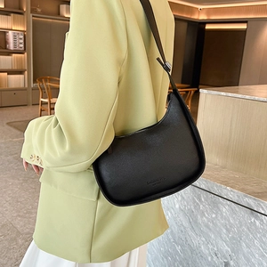 Minimalist black crescent shoulder bag in grainy leather with fashion print